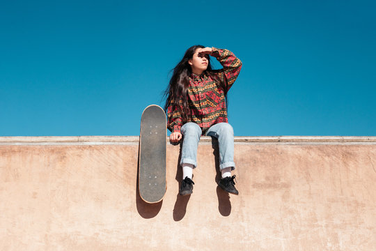 Young female skater looking at the horizon
