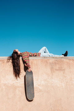 Young skater girl relaxing