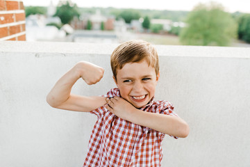 Young Boy Flexing Muscles