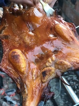 Fresh and delicious roast suckling pig, baked in a homemade red brick charcoal stove