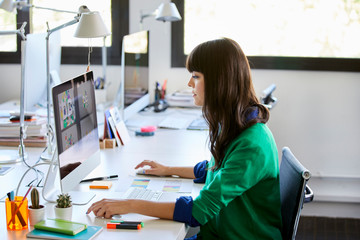 Serious Graphic Designer Using Computer At Desk