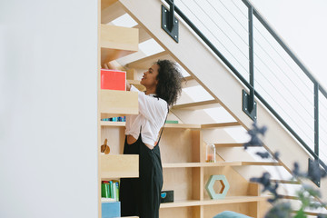 Looking at books on bookshelf