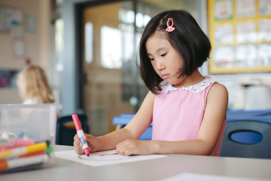Young kid drawing in classroom