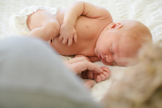 Mom and baby on bed