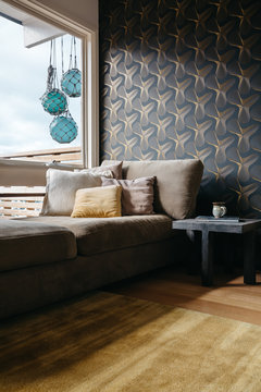 Cosy corner living room nook with retro wallpaper