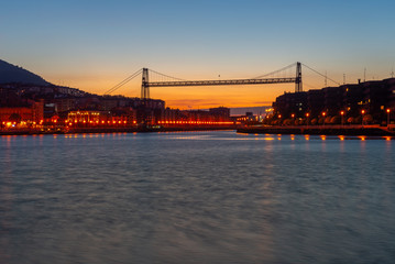 Panorama of Portugalete and Getxo with Hanging Bridge of Bizkaia at dusk from La Benedicta pier, Basque Country, Spain