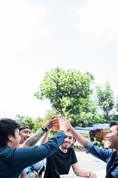 Best friends celebrating eating street food and healthy fresh juice.