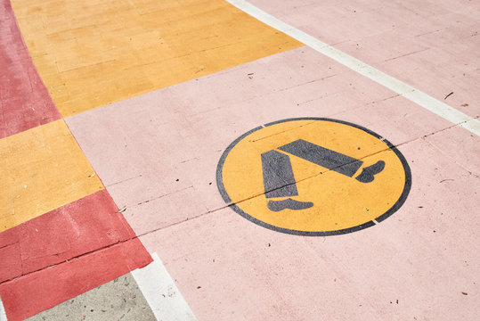 Colorful walkway with yellow symbol of human legs.