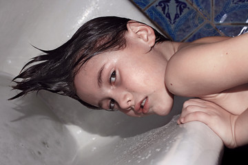 Portrait of a boy over a bathroom with wet hair