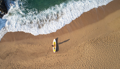 Aerial???view of surfer on beach
