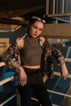 Trendy woman in modern outfit outside