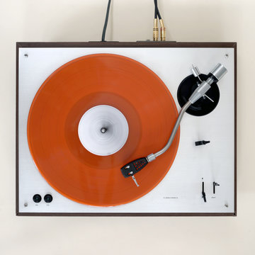 Orange record spinning on seventies turntable