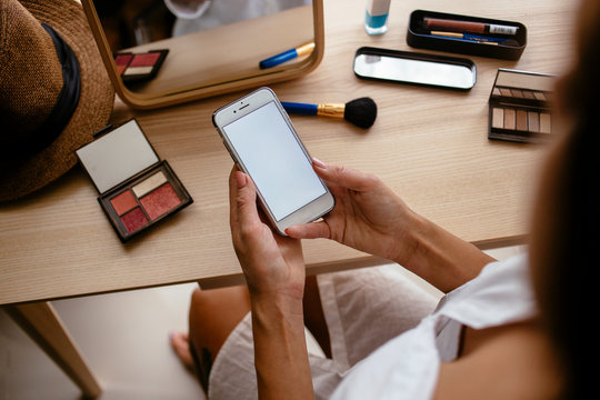 Woman doing makeup at home