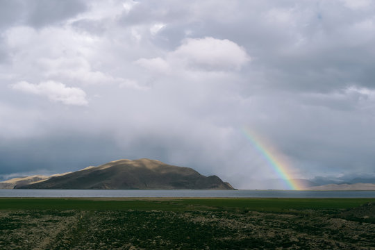 scenic view of rainbow over land in Tibet against sky