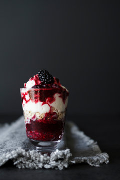 Vanilla cream with blackberry sauce and oats