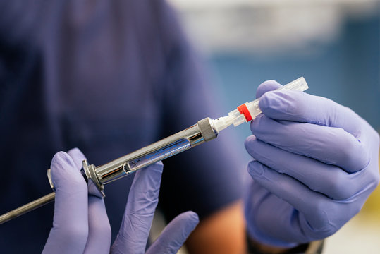 Doctor with syringe is preparing for injection