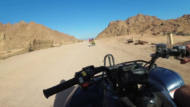 Riding a Quad in the Desert of Egypt. First-person view. Rides ATV bike.