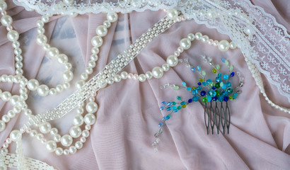 Wedding background with pearls and hair accessories on pink background