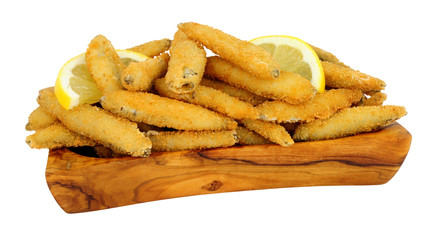 Fried bread crumb covered whitebait fish in an olive wood dish isolated on a white background