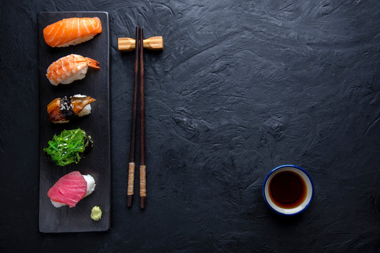Set of sushi on dark stone table. Top
