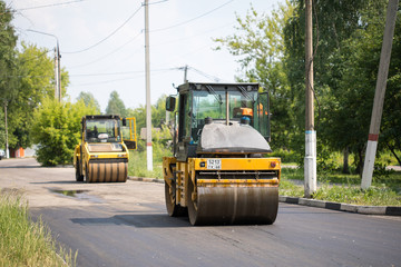 SHATURA, MOSCOW REGION, RUSSIA - JUNE 09, 2019: Repair of roads, highways and sidewalks. Laying of new asphalt pavement.