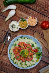 Homemade vegetable pie with carrots, asparagus, green beans, garlic, spinach, roasted peppers, cream, eggs, salt and black pepper. Tomato and cucumber salad with avocado. Salad of asparagus cucumbers,