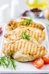 Grilled chicken breasts stuffed with spinach parmesan cheese tometoes. Selective focus, space for text.