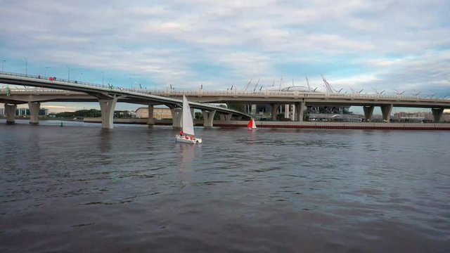 Aerial of a sailboat sailing beneath the elevated Western High Speed Diameter highway in Saint Petersburg, Russia