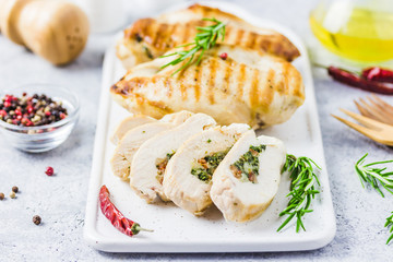 Grilled spinach stuffed chicken fillets, sliced. Selective focus, space for text.