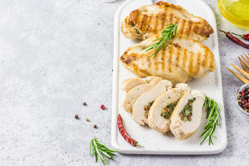 Grilled spinach stuffed chicken fillets, sliced. Selective focus, space for text.