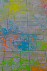 Colored powder paint on road tile. Festival of colors