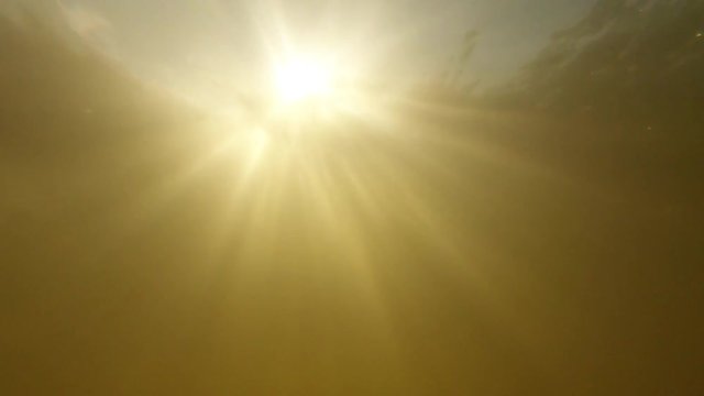 Slow Motion Of Bright Sun Light From River Underwater.