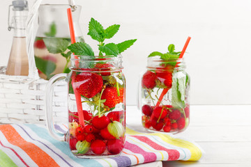 Two glasses with drink of fresh ripe berries on beautiful towel