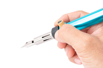 Hand holding a gas heated soldering iron isolated