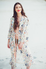 Girl walks on desert. Beautiful woman is walking, staing on sand or dune.