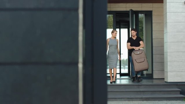 Confident couple going out modern building. Closeup rich couple going outside
