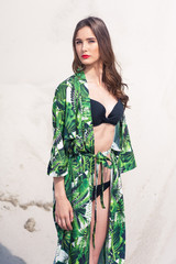 Sexy young woman posing on the sand