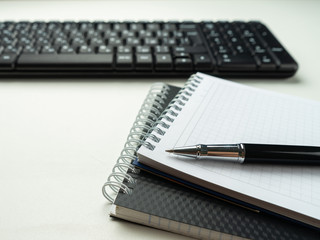 Office desk table with computer keyboard and supplies. On white background. Copy space. Mock up.