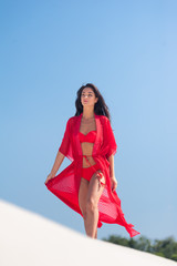 Summer Fashion. Sexy European Woman In Red Swimsuit On Beach