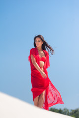 Summer Fashion. Sexy European Woman In Red Swimsuit On Beach