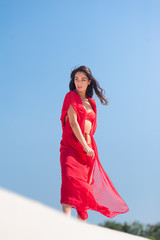 Summer Fashion. Sexy European Woman In Red Swimsuit On Beach