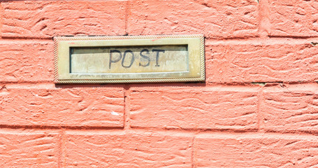 Old letterbox in the door, traditional way of delivering letters to the house, old mailbox