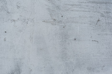 Texture of a concrete wall with cracks and scratches which can be used as a background