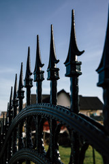 Naklejka premium Closeup of black metal fence spikes perspective
