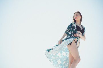 Beautiful woman summer swimwear on the sand 
