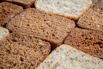 Close-up view of wholmeal bread slices, pattern effect. Whole-grain bread with visible detailed texture, diverse types
