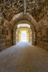 Obraz premium Mamluk era arched stones tunnel leading to Al-Muayyad Bimaristan (ancient hospital), Darb El Labbana district, Cairo, Egypt