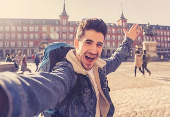 Crédence de cuisine en verre imprimé Madrid Handsome young student tourist man happy and excited taking a selfie in Madrid, Spain