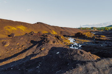 Industrial landscape of abandoned smoke stacks and waste removal plant.