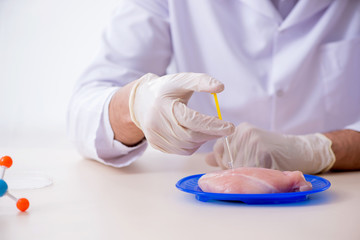 Male nutrition expert testing food products in lab